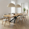 Solid oak extendable Bespoke oak dining table with a spider steel base in a modern dining room setting.