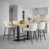 Modern kitchen interior featuring an oak Kitchen breakfast bar with seating in a stylish open-plan home design.