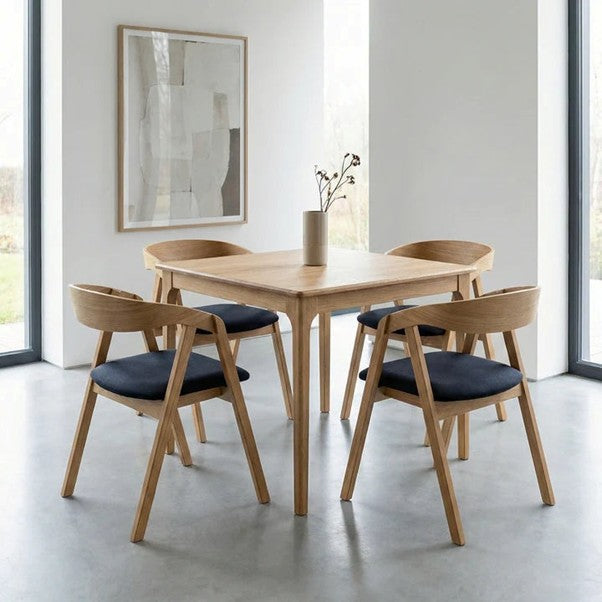 Handcrafted solid oak dining table set with matching chairs showcasing Bespoke handmade furniture in a modern home dining space.