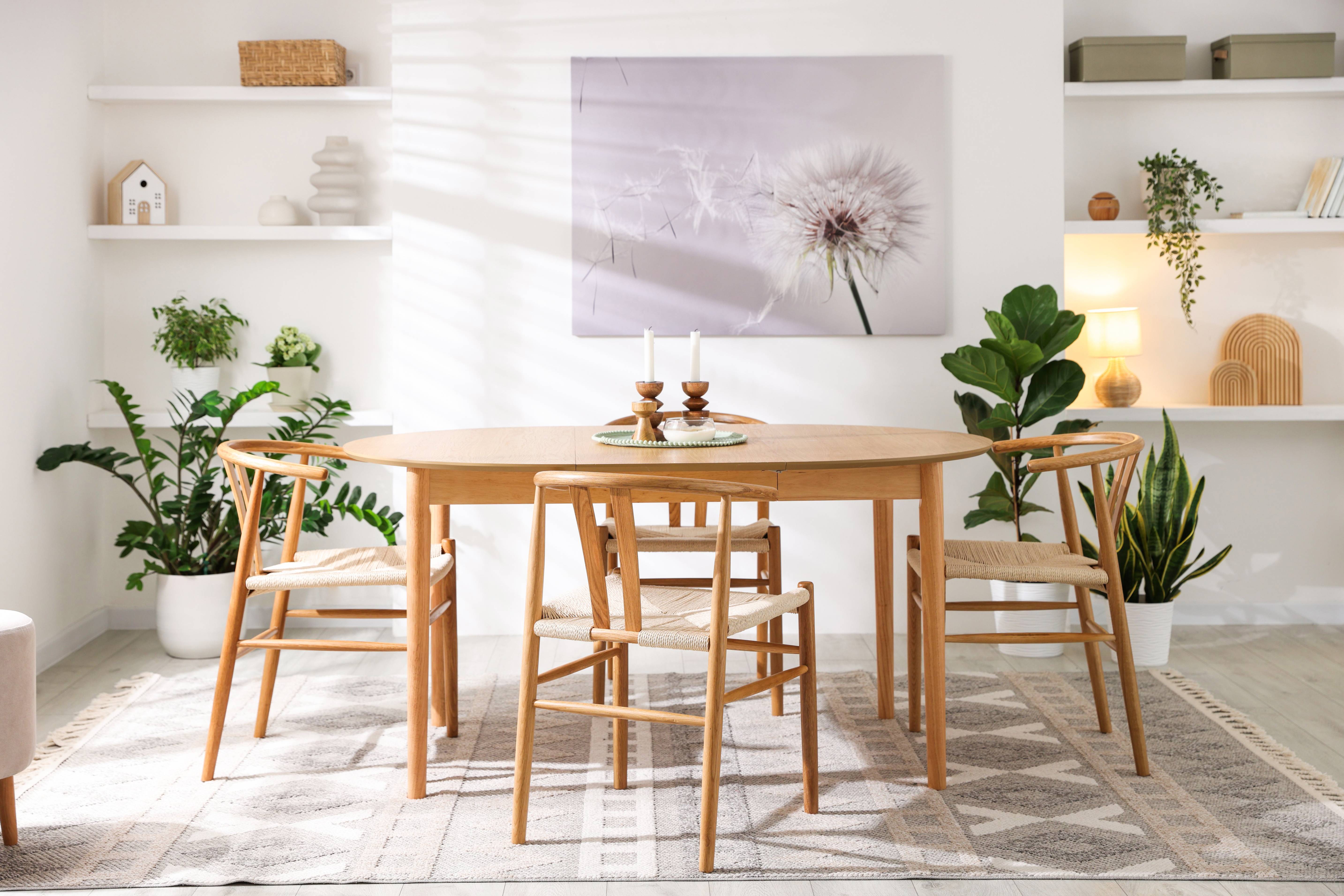 Extending oak dining table shown in a bright dining room with wooden chairs and natural décor.