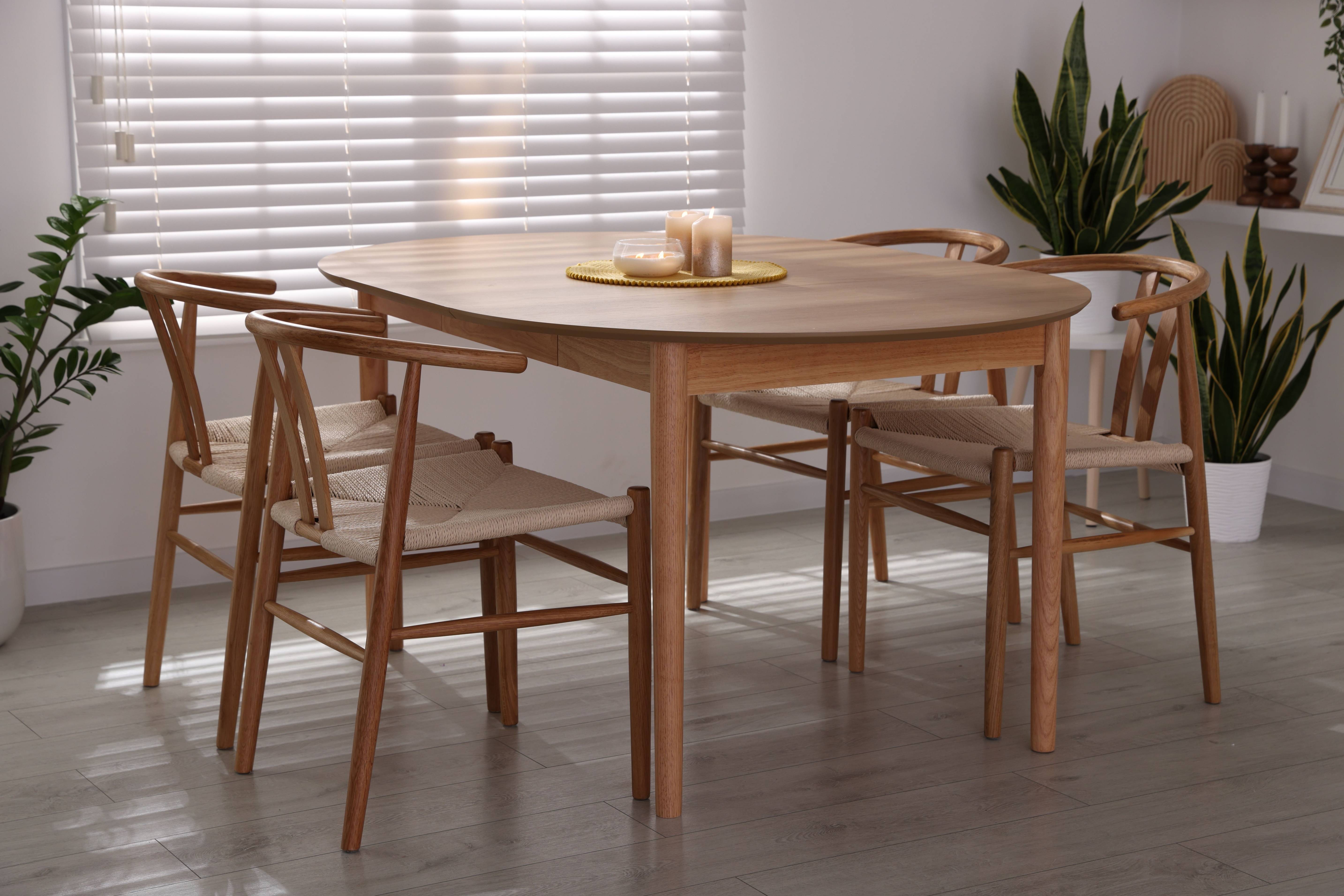 Oak dining tables in a modern dining room with wooden chairs and natural interior décor.